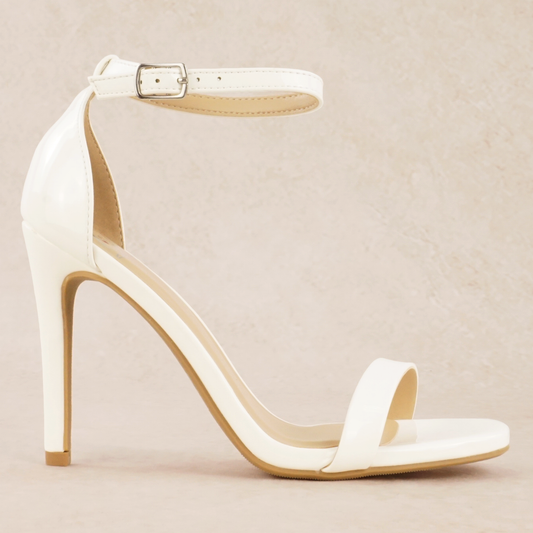 A white patent material stiletto heel with adjustable ankle strap