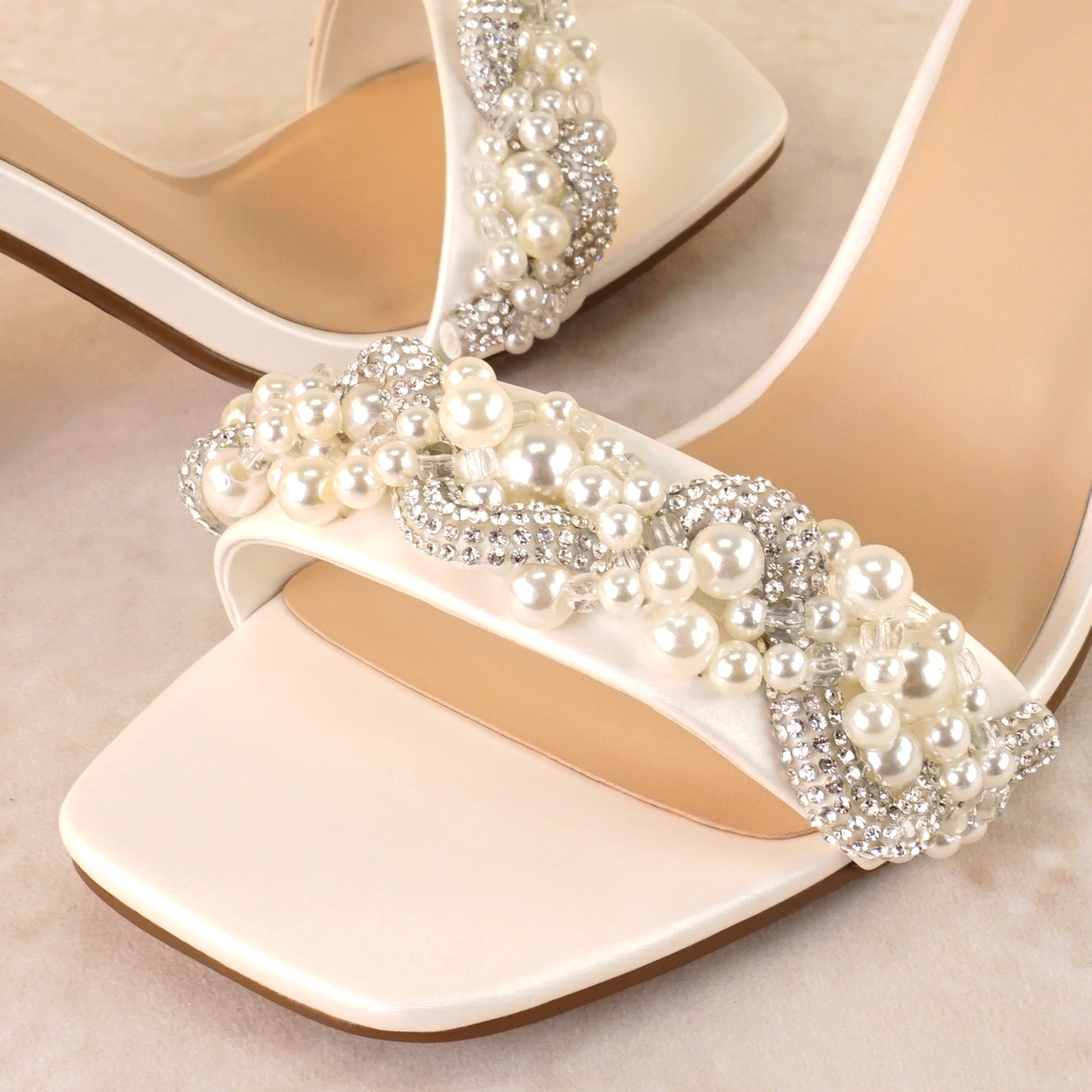 Pearls and rhinestones intertwined on a white single-band 3.25" ankle strap block heel