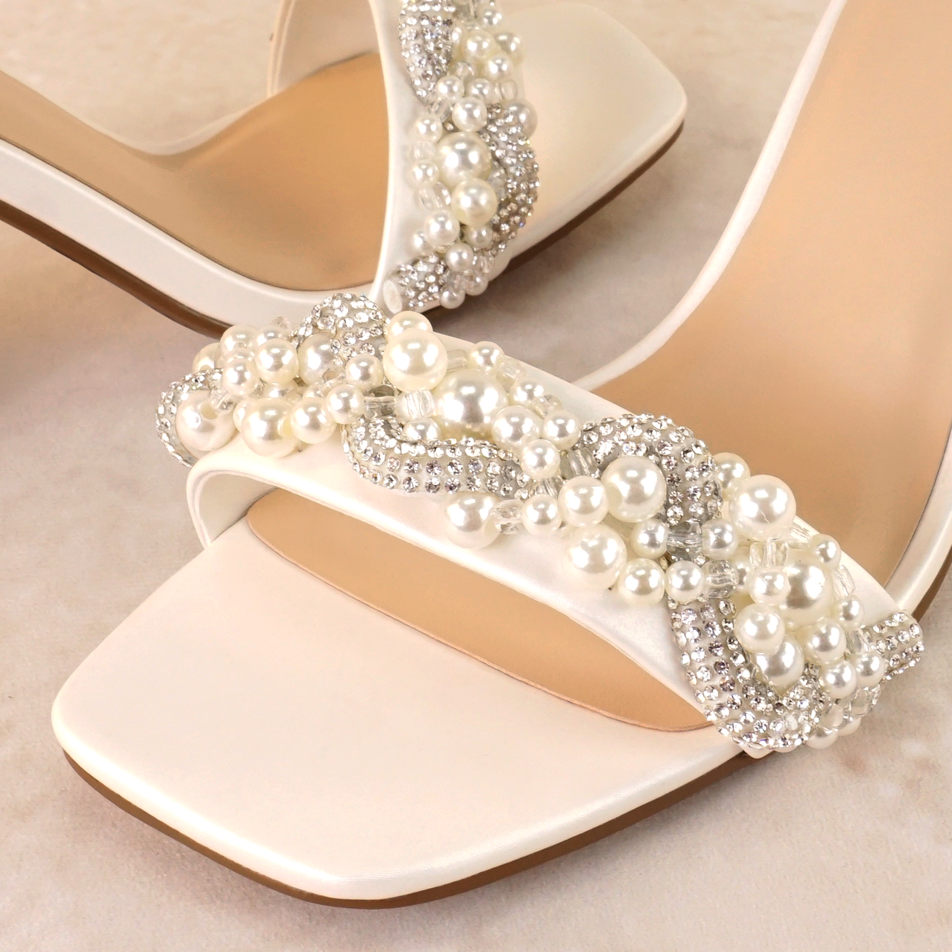 Pearls and rhinestones intertwined on a white single-band 3.25" ankle strap block heel